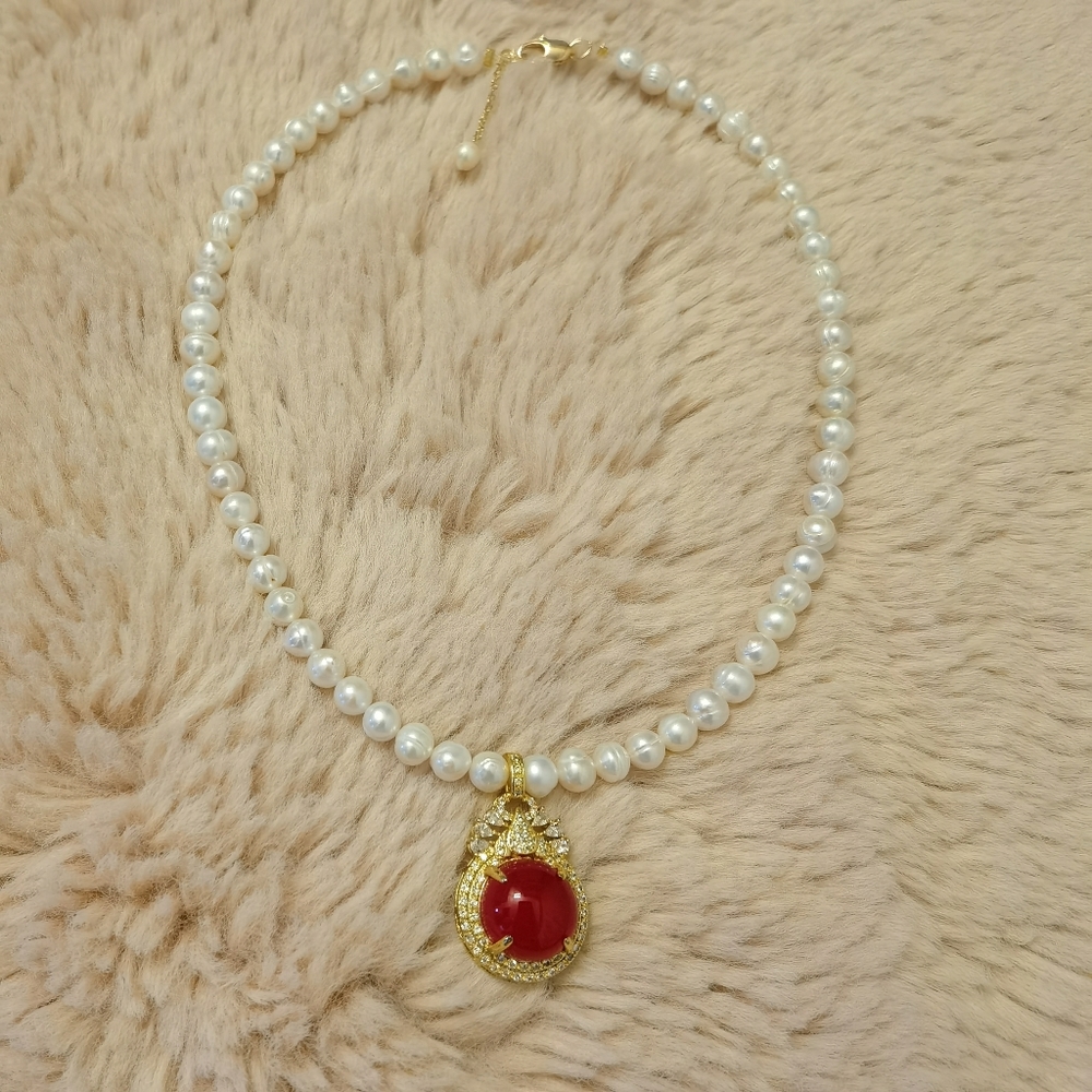 Pearl necklace with red agate pendant.